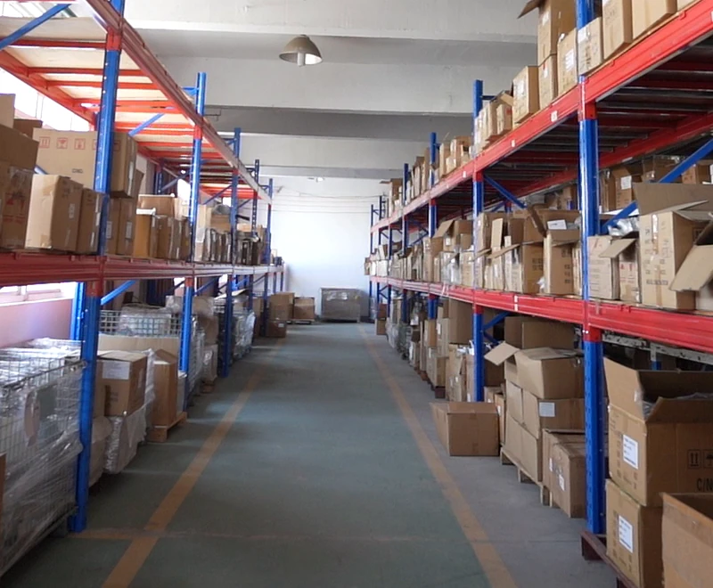 An aisle between racks and containers.