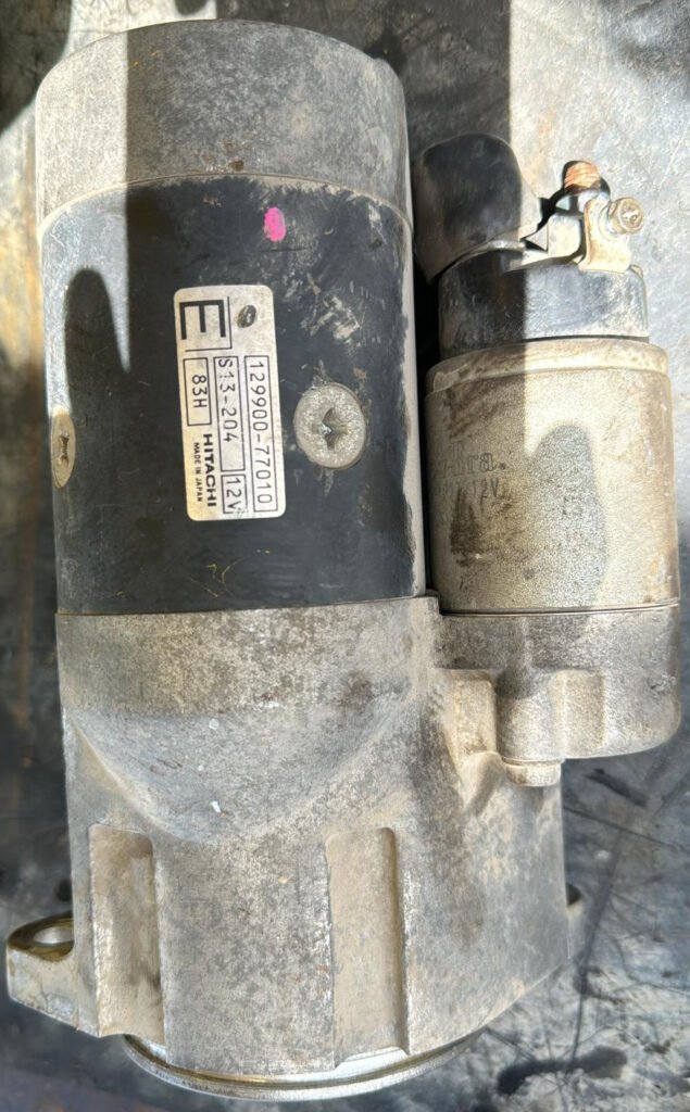 Photographed starter body and adjacent solenoid with its original printed label retained.