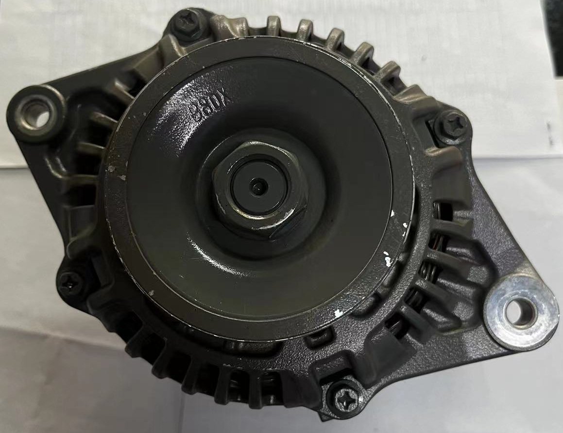 Front-facing alternator with a dark circular pulley, a central fastener, housing openings and projecting mounting ears.