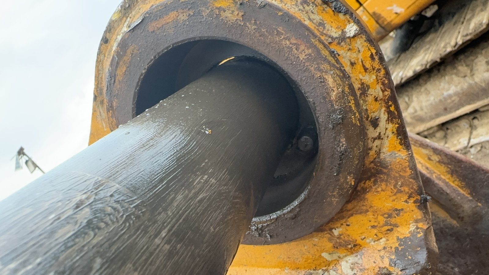 A close view of a cylinder rod and surrounding housing/gland area.